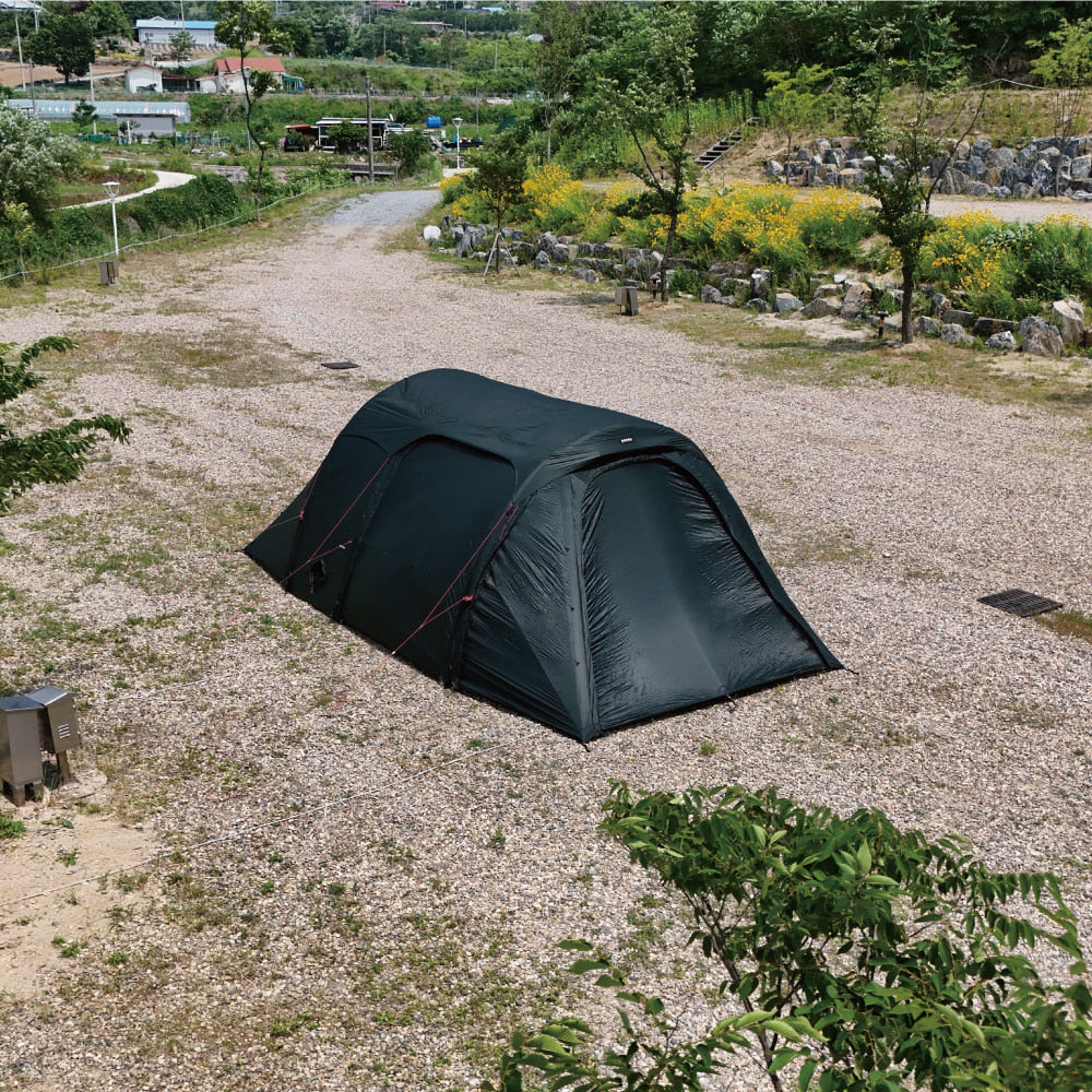 Gopamir TN600 air shelter in dark green, side view on gravel