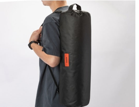 Carrying the packed cot case over one shoulder