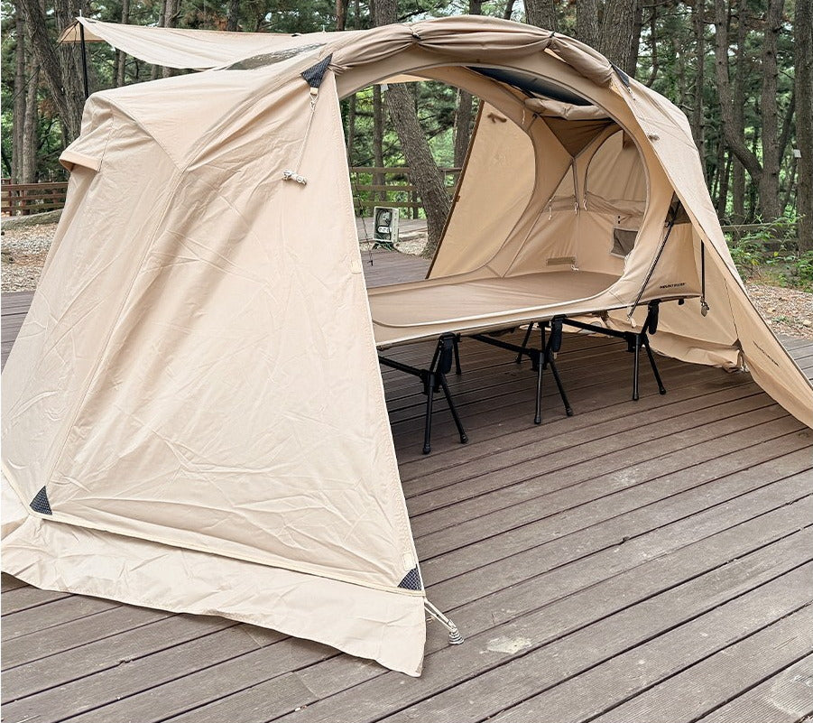 Neo Nest 80 rainfly pitched over a cot tent on a deck, both doors rolled open (tent and cot sold separately).