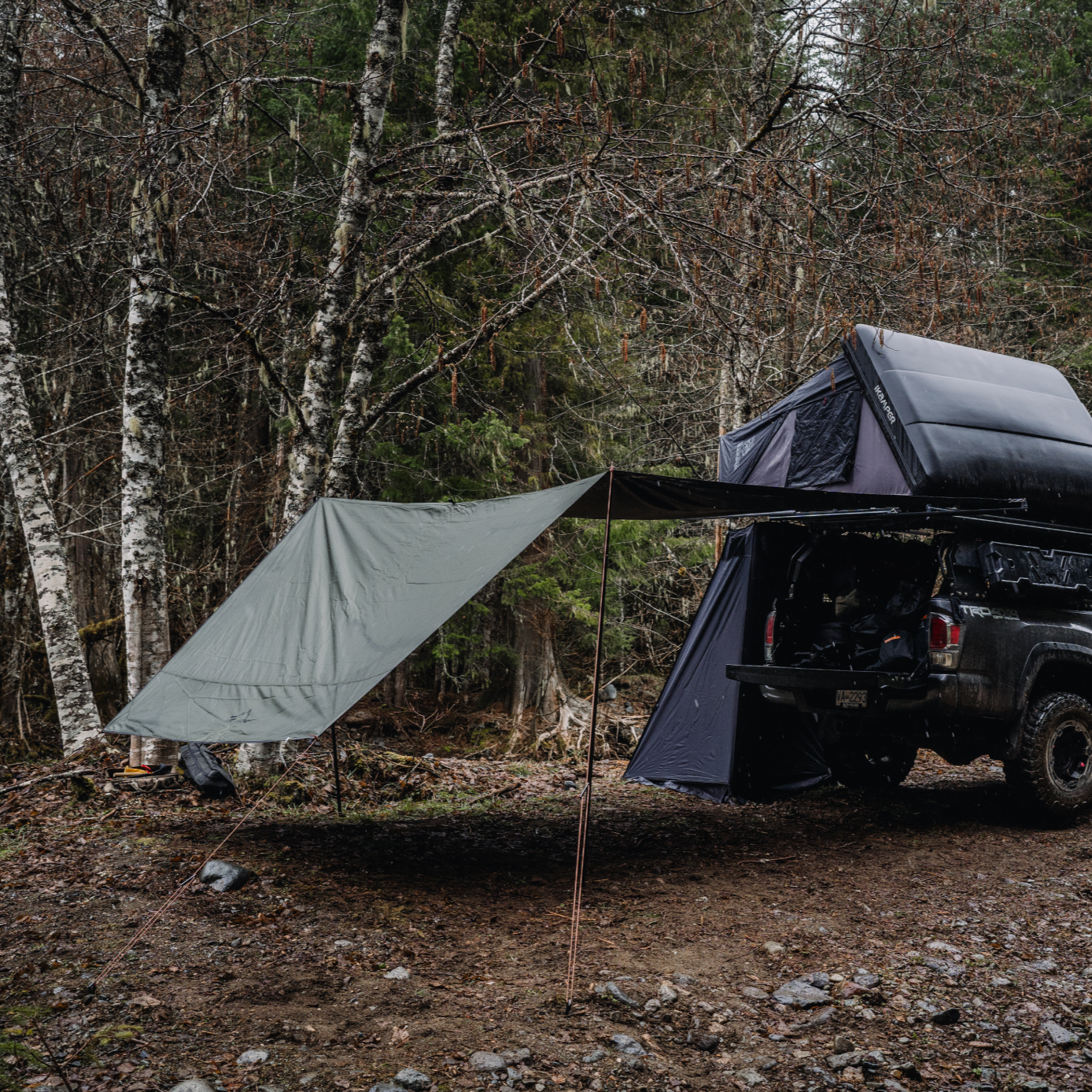 The ES Awning Set of 1300 is pitched with ikamper Skycamp 3.0 on Toyota Tacoma Off Road.