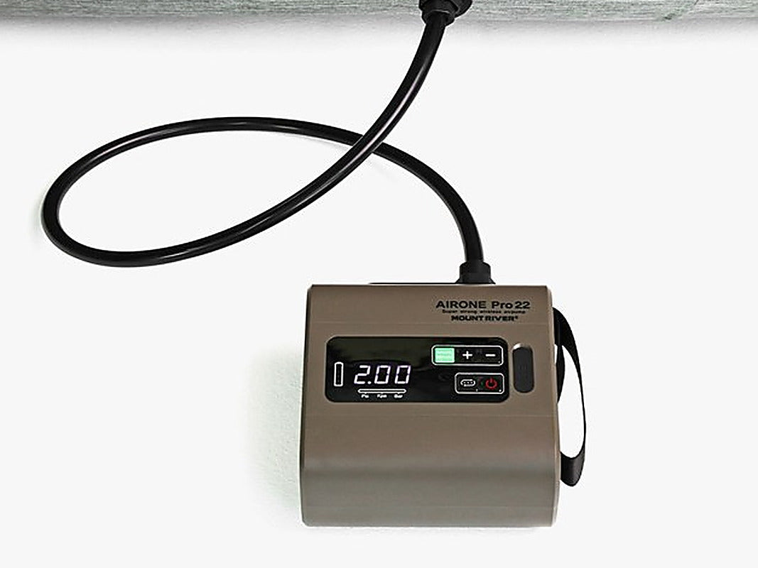 Air One Pro 22 pump on an air mat with its hose connected and the display showing a pressure reading.