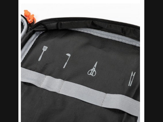 Interior of the storage case showing printed tool icons above the elastic bands