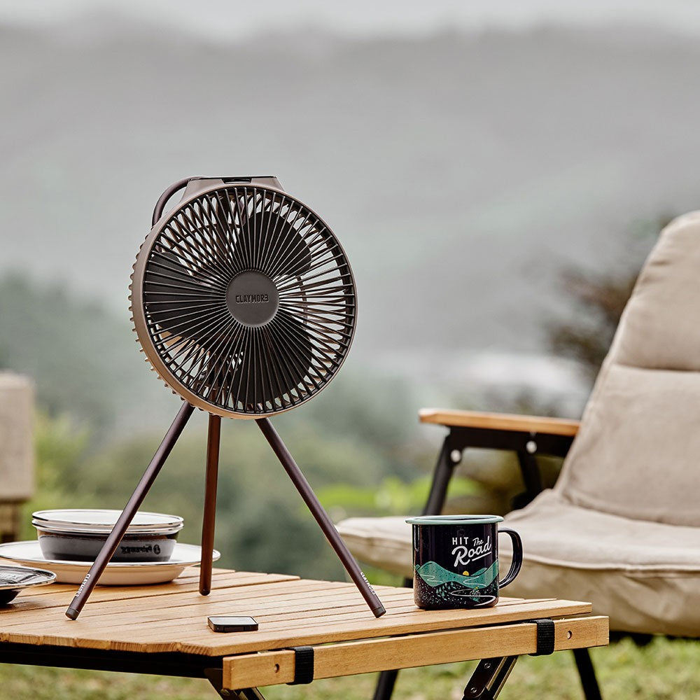Warm Grey V1040 fan on a wooden table indoors next to a mug