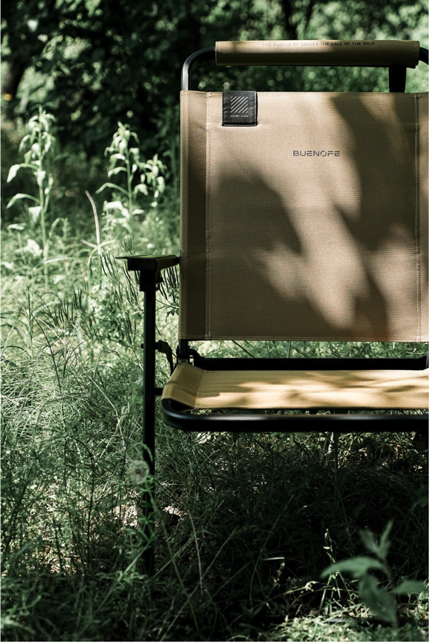Tan FLOW folding chair close-up showing the CX-01 FLOW label and headrest artwork