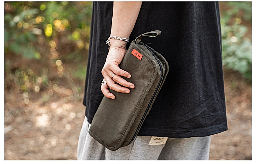 Folding BBQ Chair packed case held in hand outdoors, in Khaki