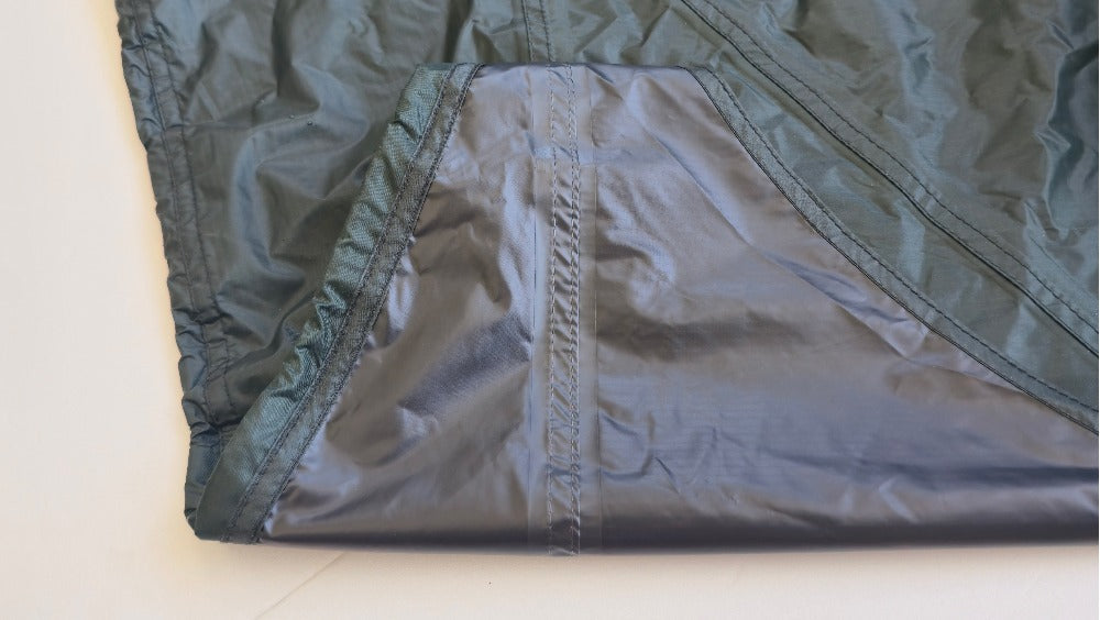 Close-up of the TN600 rain fly fabric showing the silicone-coated surface and stitched seam