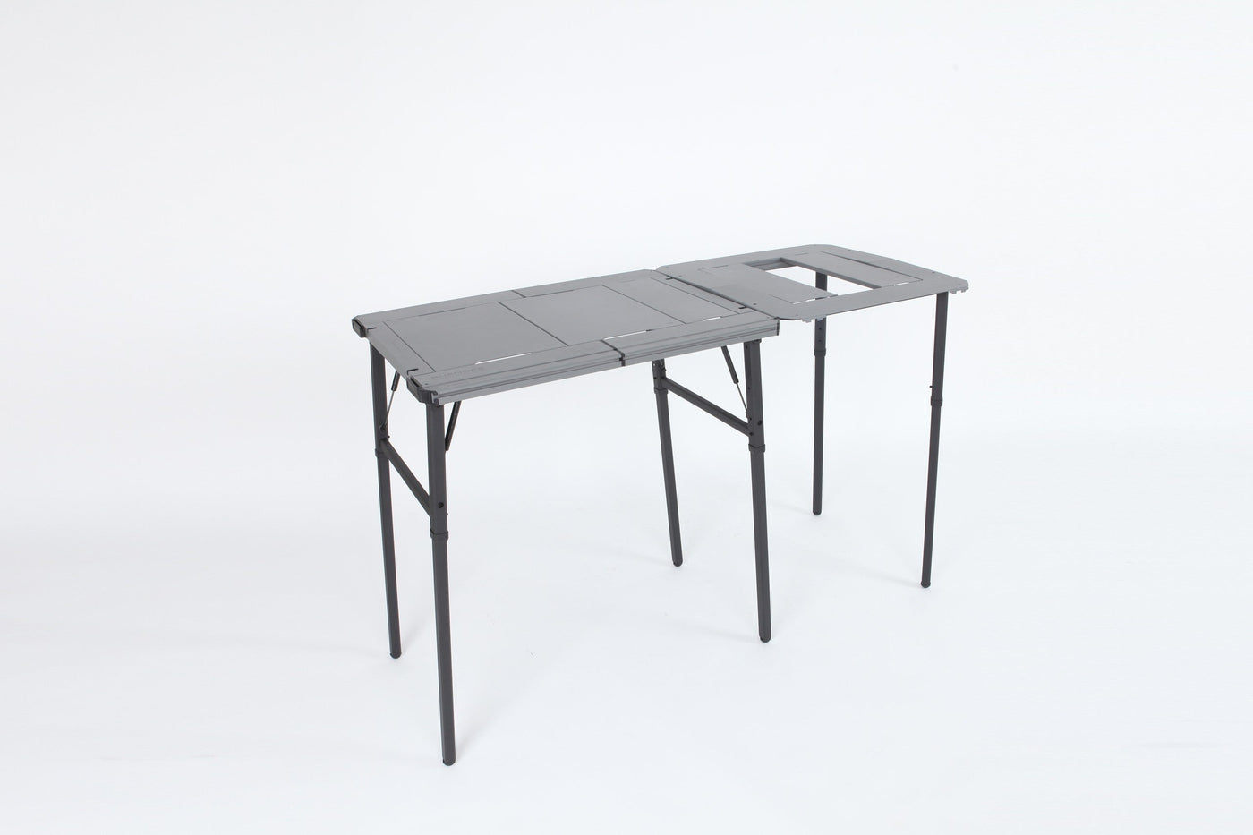 Three-quarter studio view of the BUENOFE IGT Connect Table 1.5 bridging two IGT tables into a long continuous work surface on a white background.