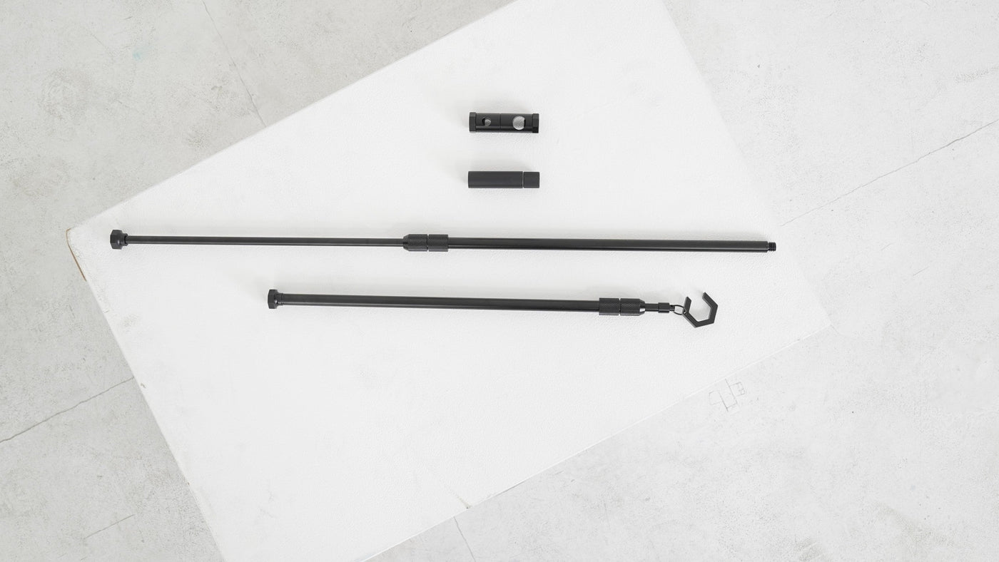BUENOFE IGT Lantern Hanger components laid out flat, showing the base pole, the hanger pole with its C-hook, and the small pole connector and bracket parts arranged together to show everything included in the set.