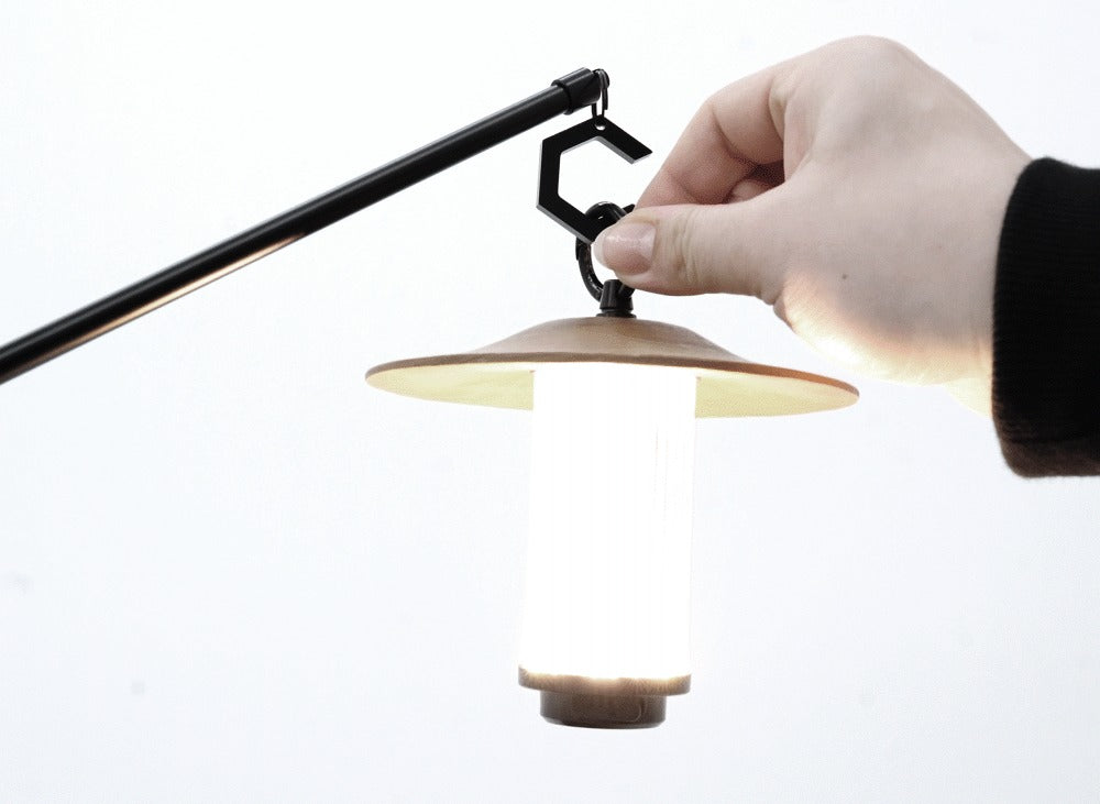 BUENOFE IGT Lantern Hanger installation step 5: a hand hangs a lit lantern onto the hexagonal C-hook at the end of the boom arm.