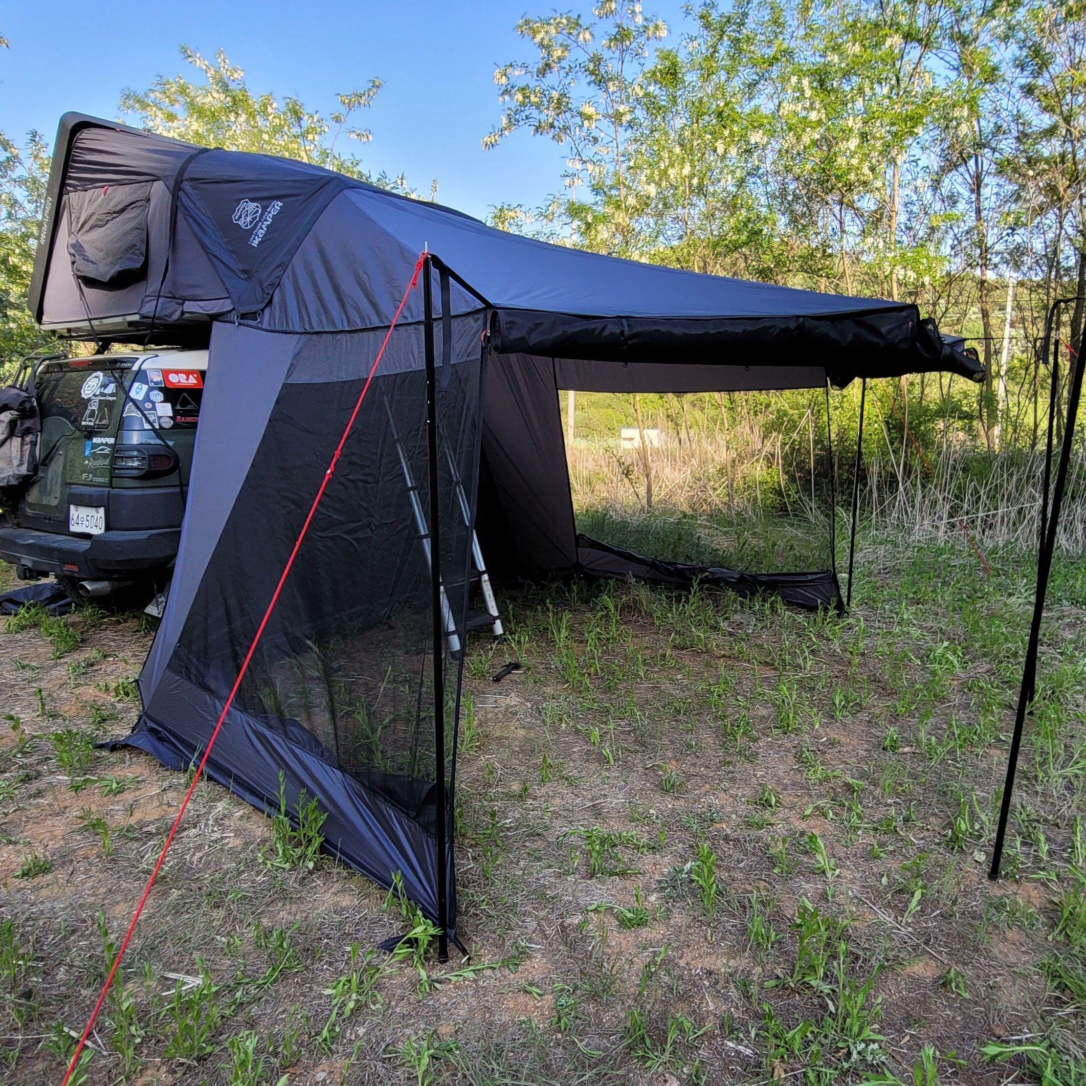 LNT Overland awning mesh screen is installed with iKamper Skycamp and fully opened.