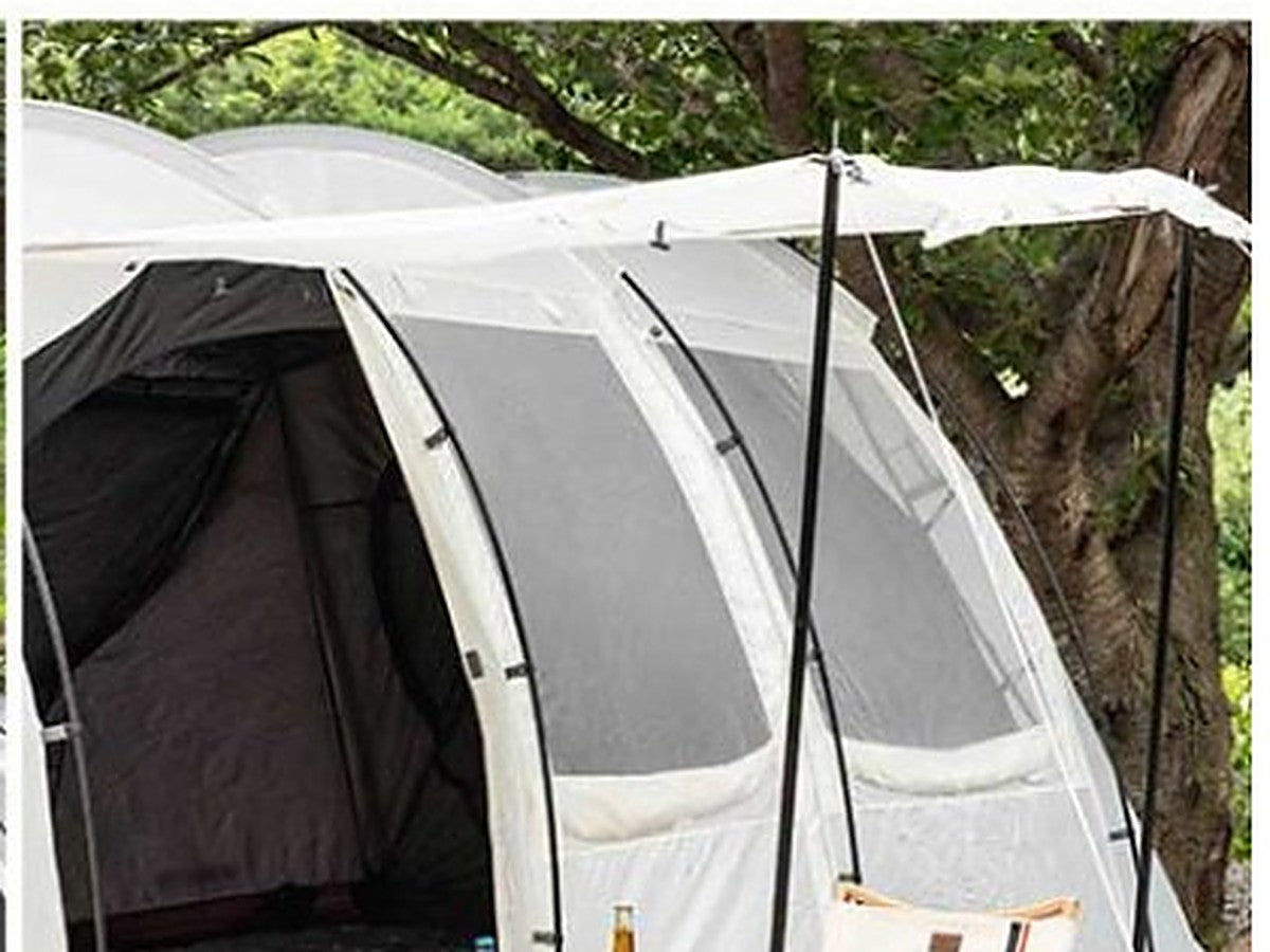 Front door propped open with poles as a shade canopy over the camp setup
