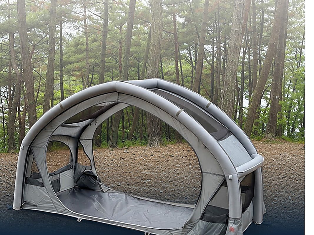 Neo Nest 80 Air pitched on the ground without a cot, front door open, in a pine forest.