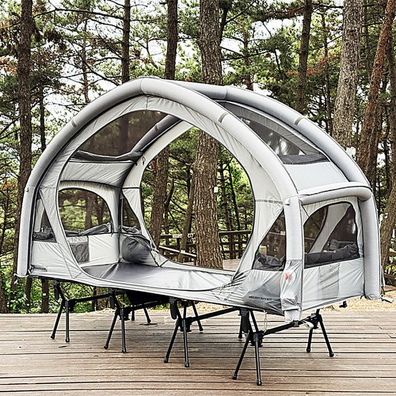 Neo Nest 80 Air on a camp cot (sold separately) on a wooden deck with both doors open.