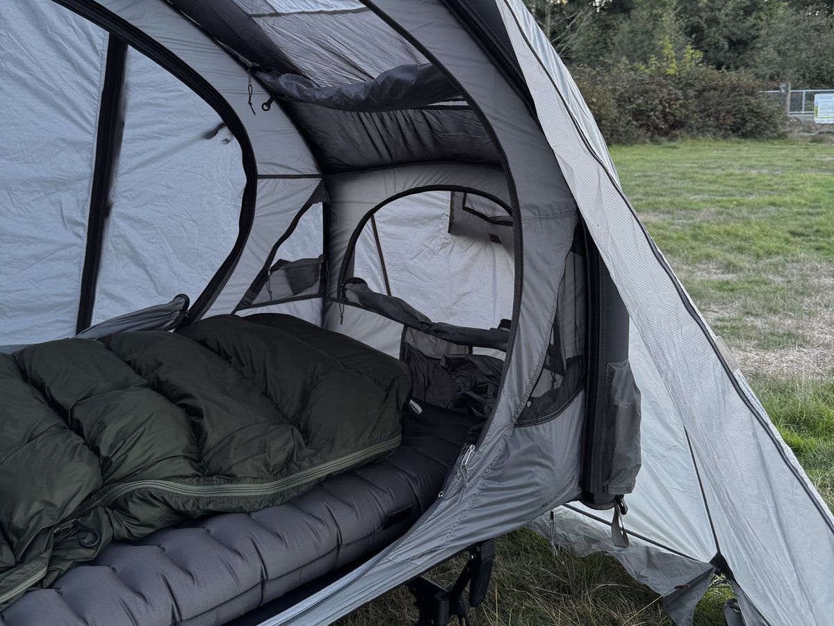 Air rainfly door held open, cot and bedding inside the tent (tent, cot, pad and sleeping bag not included).