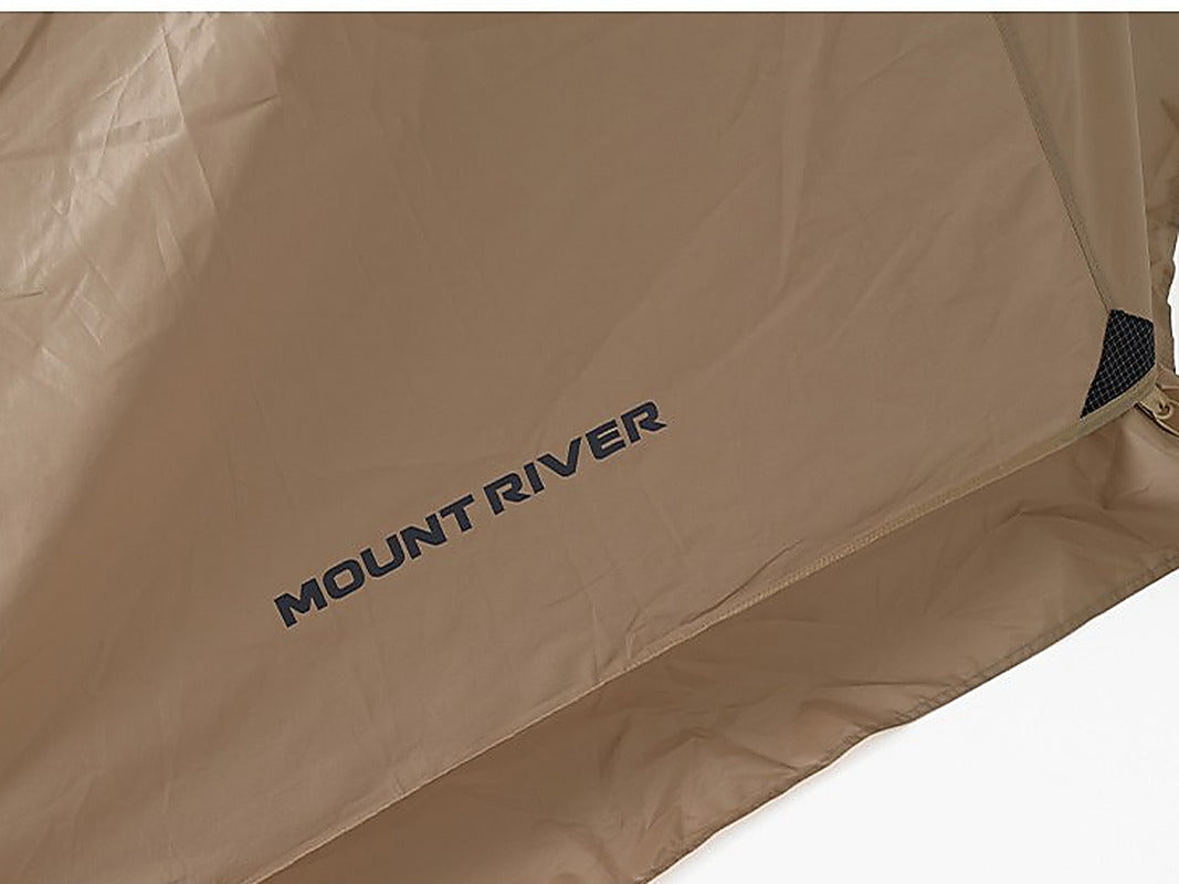 Close-up of the tan polyester Oxford rainfly fabric with a taped seam, corner patch and printed Mount River logo.