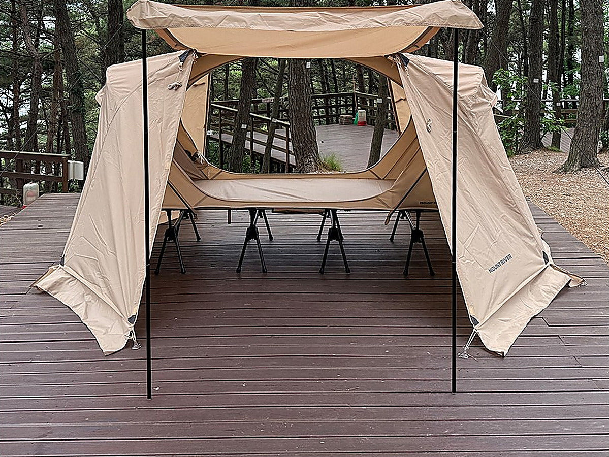 Front view of a tan rainfly door held flat as an awning by two upright poles (tent, rainfly and cot sold separately).