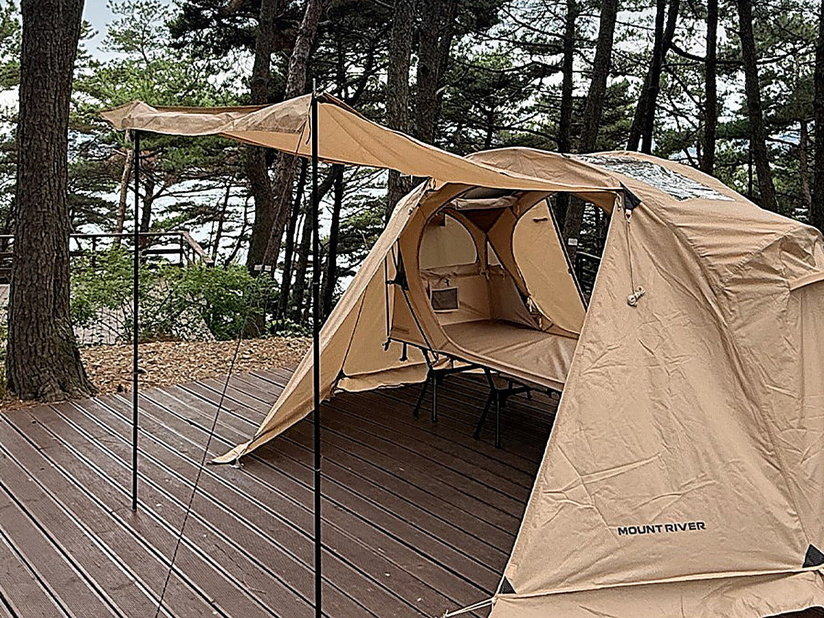 The pair of door poles holding one tan rainfly door open as a side canopy (tent, rainfly and cot sold separately).