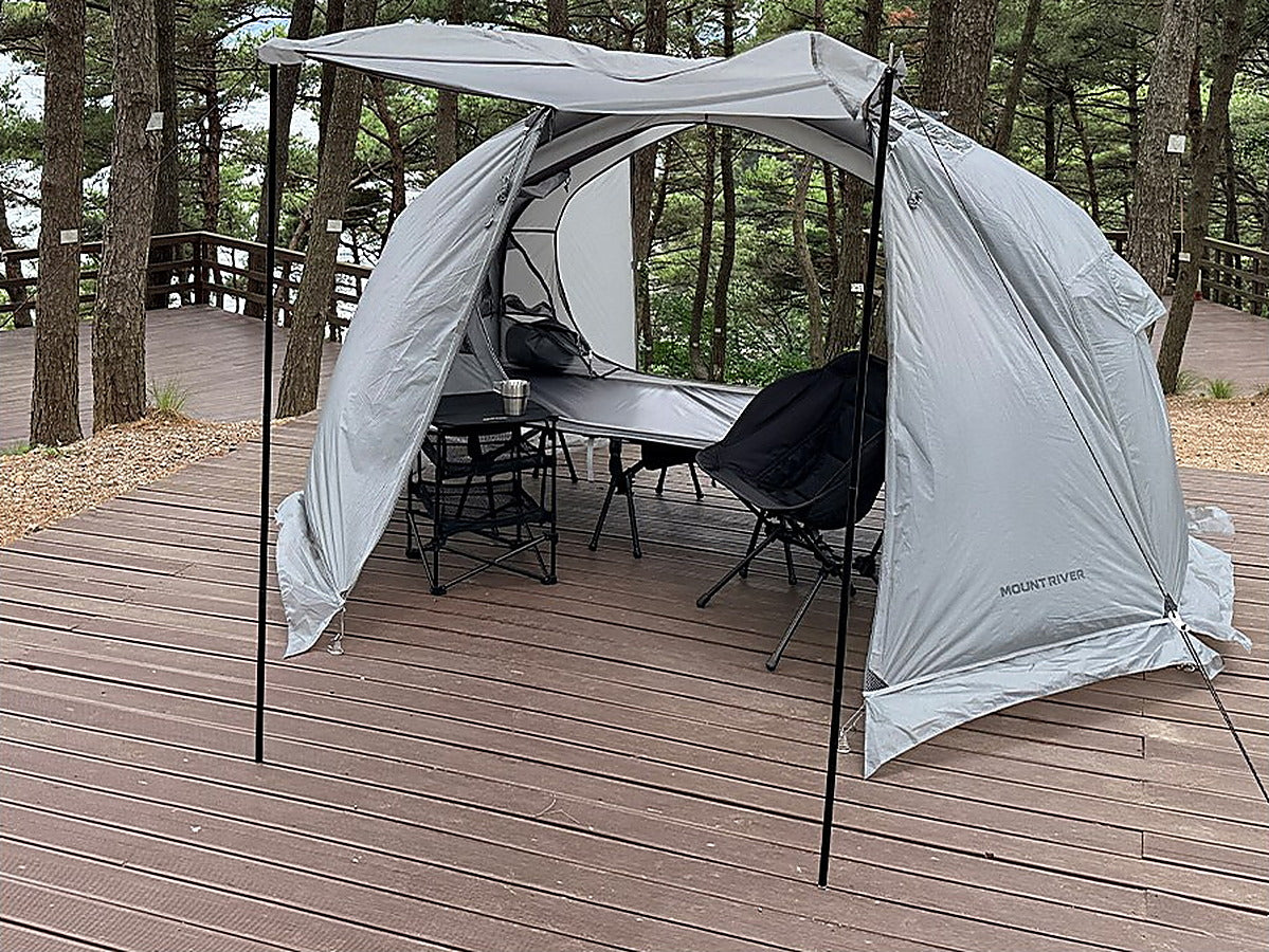 Two door poles prop the grey rainfly door open as a front canopy on a deck (tent, rainfly and cot sold separately).