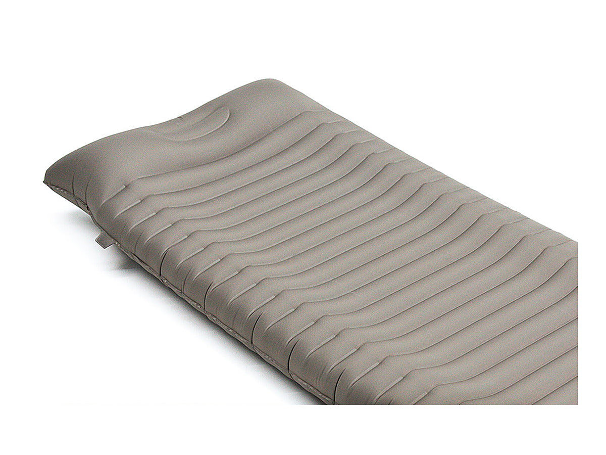 Three-quarter view of the inflated pad showing the transverse wave air cells across the sleeping surface.