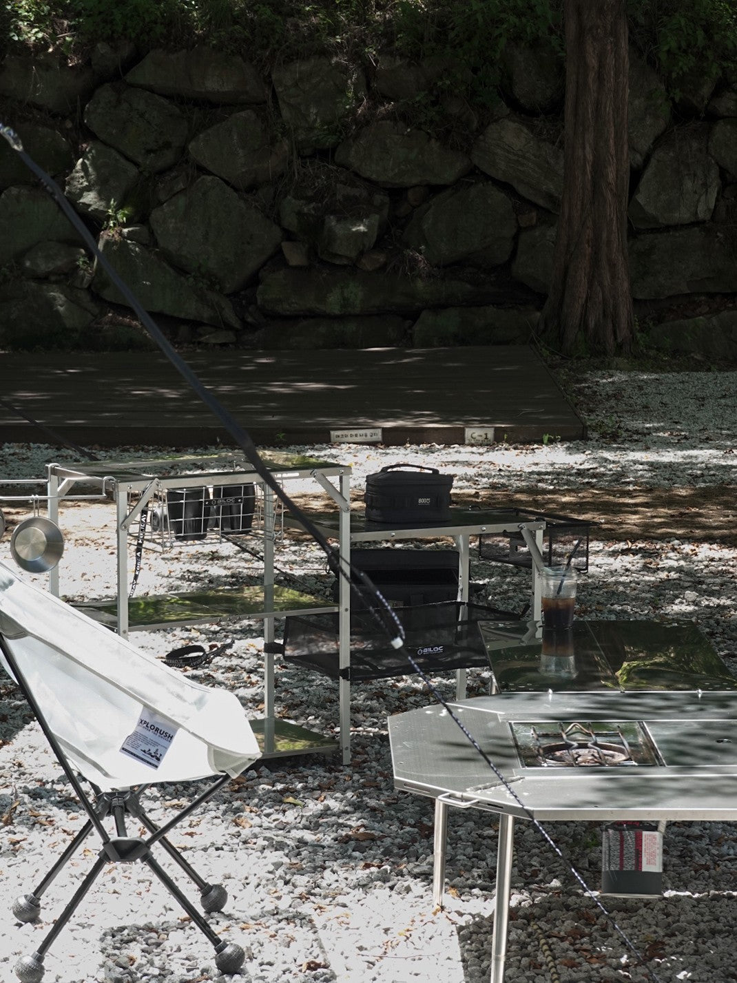 Biloc Stella shelf kitchen corner with chair and table at a shaded campsite