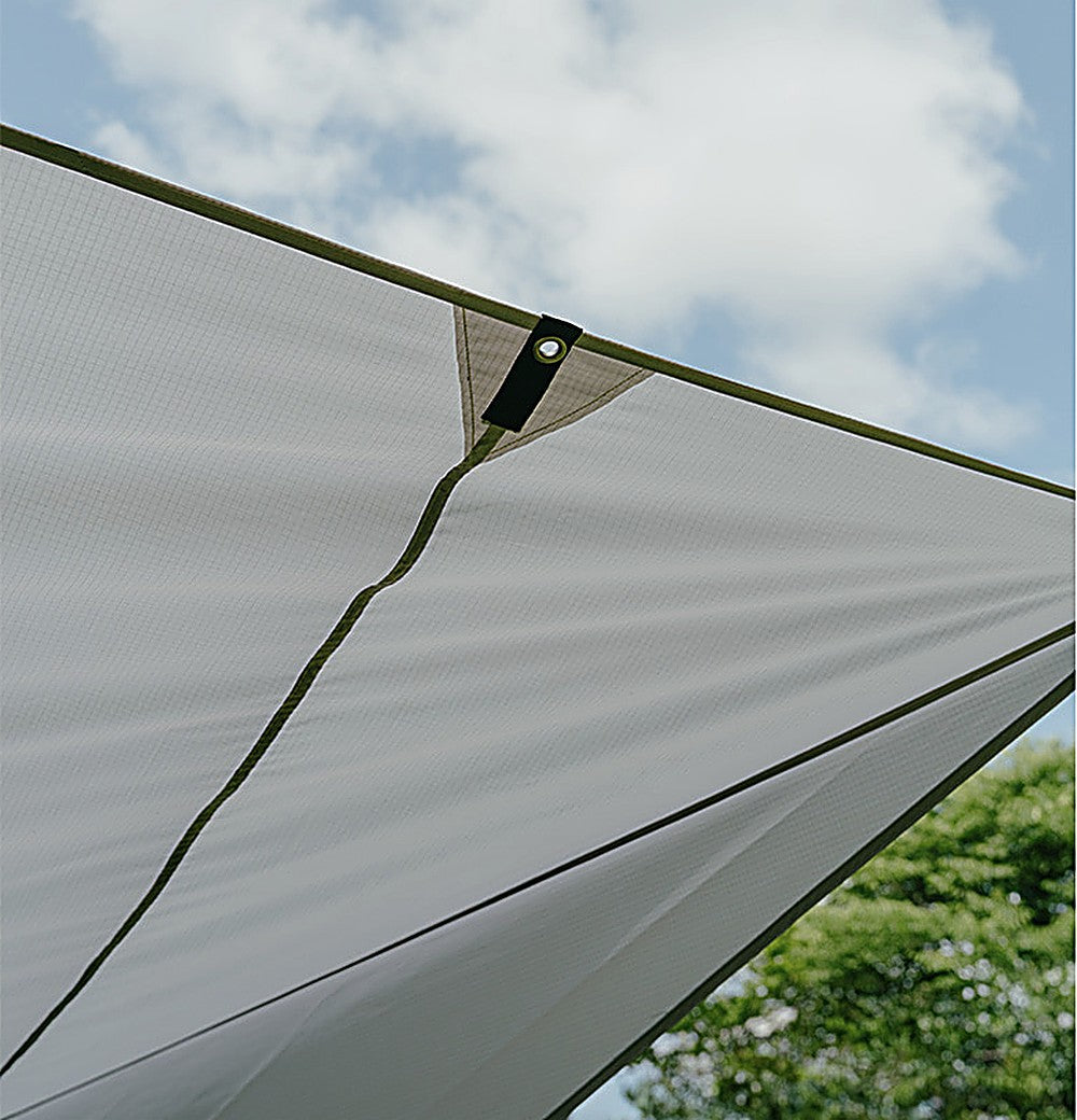 Detail of the PU-coated polyester canopy fabric and reinforced apex panel against a blue sky