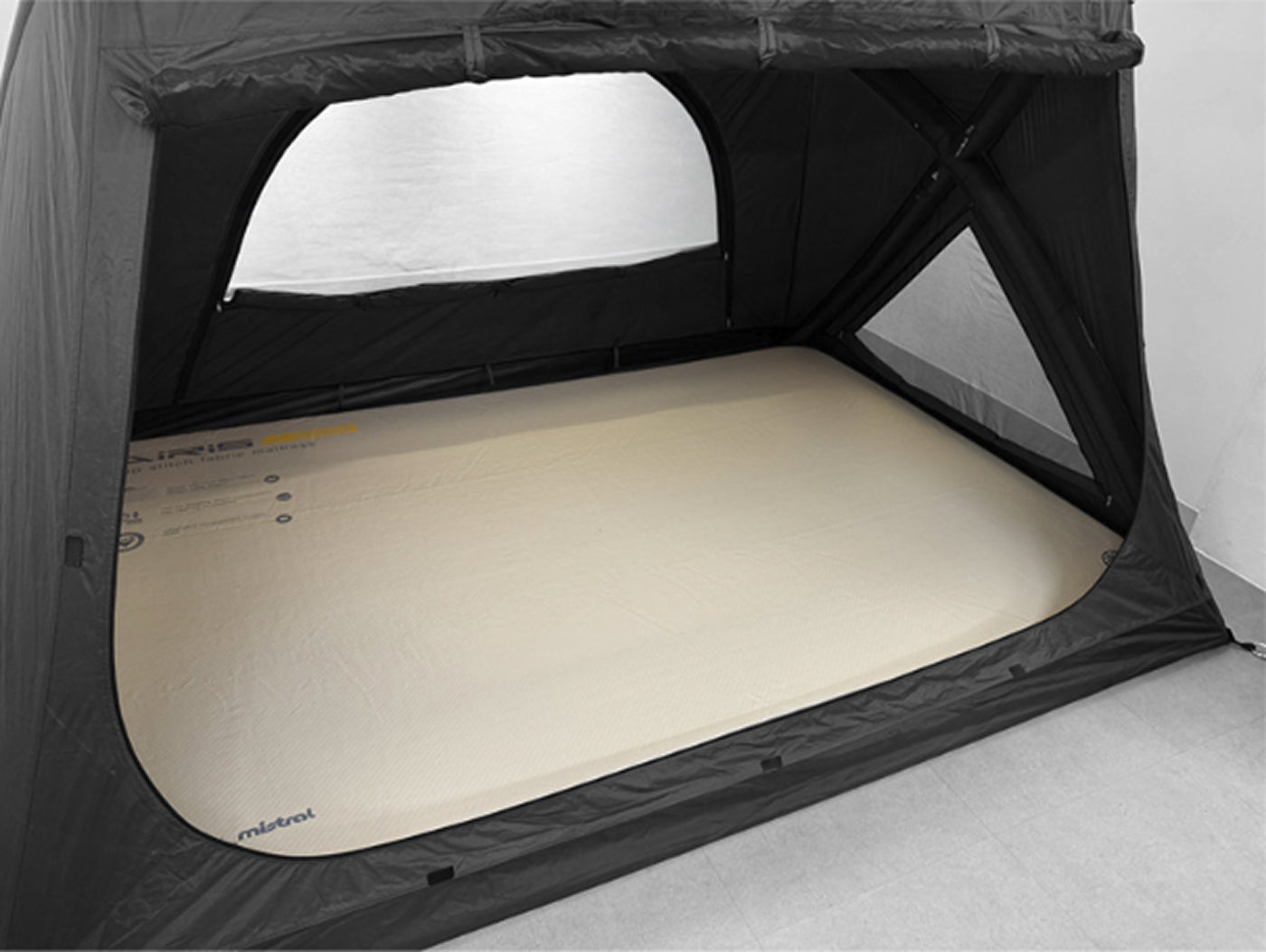 Interior view showing pendleton-style air mattress laid across the floor with full standing headroom and rear mesh window